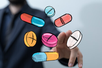 Stock photo of hand interacting with colorful sketched pills and capsules.  Perfect for healthcare, medicine, or pharmacy.