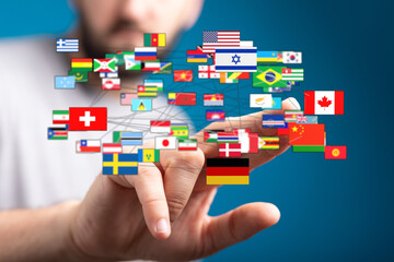 A hand supporting interconnected flags of the world, symbolizing global connections, cooperation,...