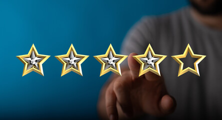 A person's hand points at four stars out of five, representing customer satisfaction, ratings, quality, and success. Perfect for reviews, feedba