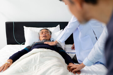 scene of bedridden patient, elderly hopeless senior man lying on bed with oxygen mask by doctor. home caregiver nurse visit retirement patient for health check up recovery process medical service
