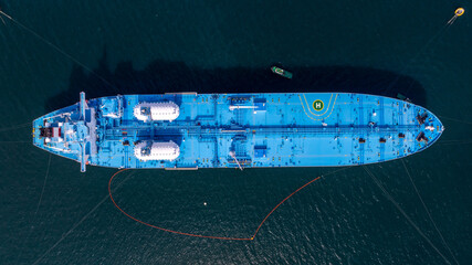 Aerial view oil ship tanker vessel loading and unloading in oil terminal station refinery, Global business import export logistic transport sea freight cargo tanker, Blue crude oil tanker ship at port