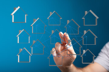 Hand interacting with a network of home icons representing real estate, smart home, and digital concepts. Illustrating connectivity and future t