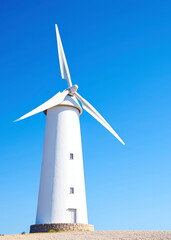 A modern wind-powered lighthouse on an island