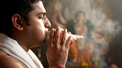 Hindu priest blowing conch shell suitable for religious ceremony, event, celebration, culture ritual, belief tradition