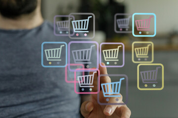 Close up of a man's finger interacting with cart icons, representing online shopping, sales and digital commerce. E-commerce design and retail c
