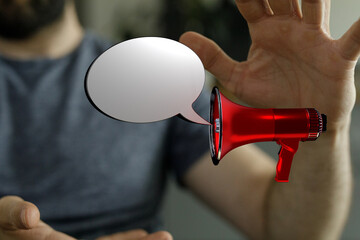 A man using a red megaphone to broadcast a message. Speech bubble represents a call to action or...