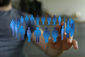 A hand reaching towards a circle of digital people icons, representing community, teamwork, and...