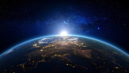 Obraz premium A vibrant image depicts the Earth, illuminated by a bright sunrise. City lights glow beneath, against a backdrop of stars