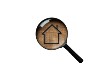 A magnifying glass over a wooden house silhouette, isolated on a stark black background