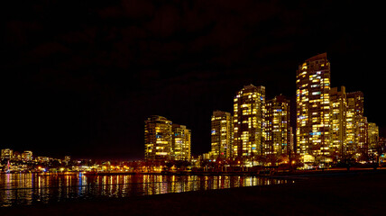 Naklejka premium Nightview of Vancouver from False Creek. Illuminated downtown of Vancouver at night