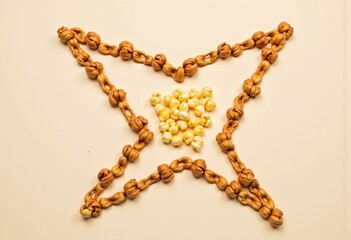 Artistic Arrangement of Popcorn Encircled by a Star-Shaped Chain of Twisted Nuts on a Minimalistic Neutral Background for Creative Snack Presentation