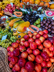 Abundance of fresh, ripe fruits displayed tightly on a farmers' market or grocery stall.The densely packed fruit creates a rich texture and pattern, emphasizing abundance and variety. 