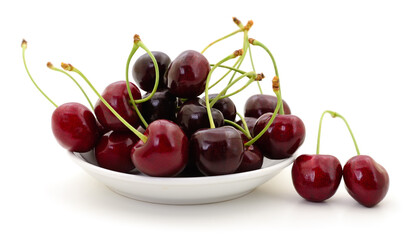 Fresh sweet cherries on white plate isolated on white background