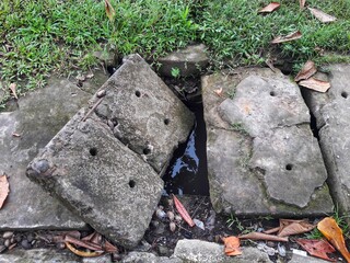 a broken cement block covering a water channel