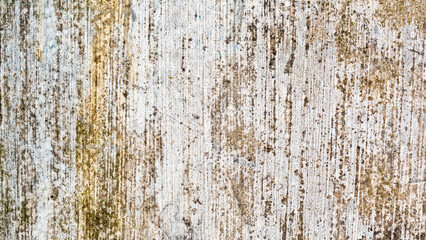a detailed close-up of a weathered white concrete wall with vertical dirt and moss stains. perfect grunge texture background.
