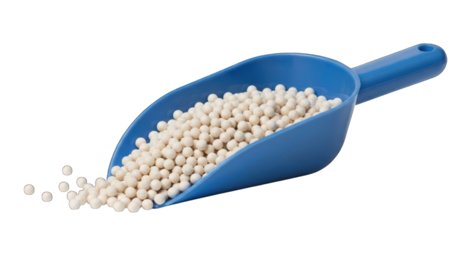 Blue scoop holding white pellets, some spilled out on a black backdrop