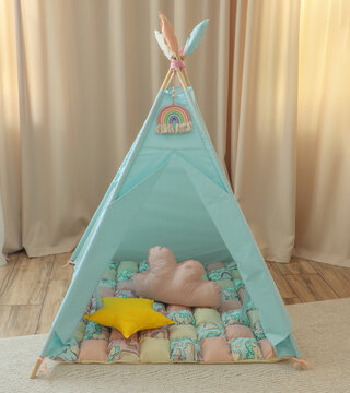Playroom with Teepee. Modern room interior with play tent for child. children's wigwam in the room on the floor Scandinavian style with decor. children's play area