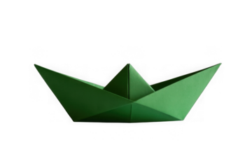 Green origami paper boat floating on a dark surface isolated on transparent background
