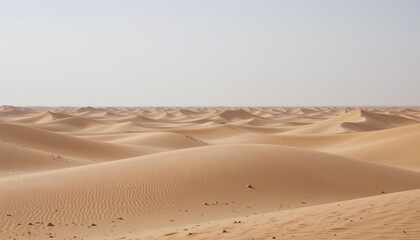 Vast Expanse of Rolling Sand Dunes Under Clear Blue Sky in a Desert Landscape