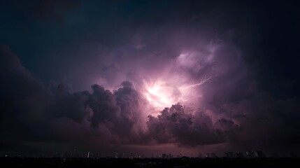 Naklejka premium A dramatic lightning bolt illuminates a turbulent dark storm sky casting an electric glow over a distant city skyline