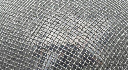 Fototapeta premium Close-up of Woven Metal Mesh with Square Openings.