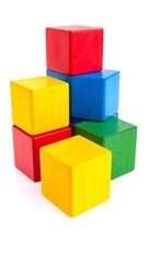 Fototapeta premium A stack of colorful wooden toy cubes against a clean white backdrop