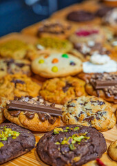 “Assorted artisanal desserts and pastries displayed on wooden table in modern bakery”