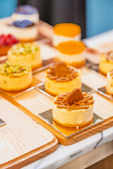 “Assorted artisanal desserts and pastries displayed on wooden table in modern bakery”