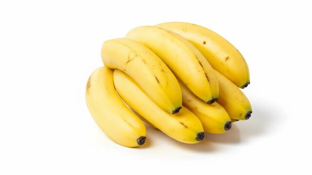 Cluster of bright yellow bananas with slight bruising on white surface