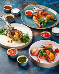 Several dishes of chicken and lamb, with herbs and sauces