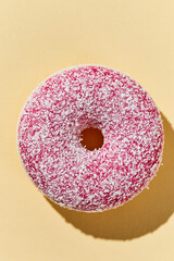 Overhead view of Delicious donut on colored background