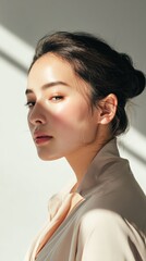 Close-up portrait of an Asian woman in natural sunlight