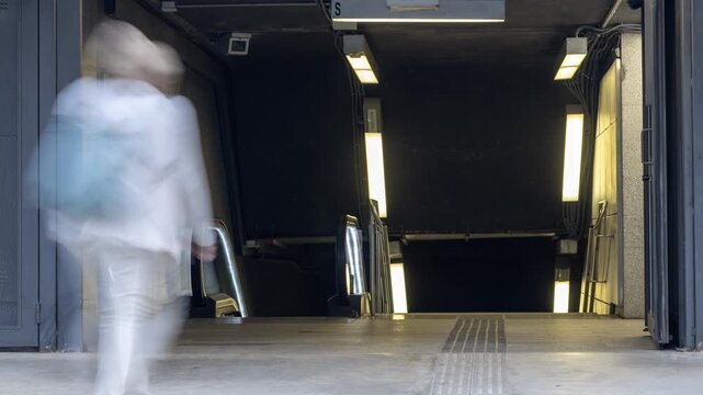 blurred rush of people entering and exiting metro station in barcelona