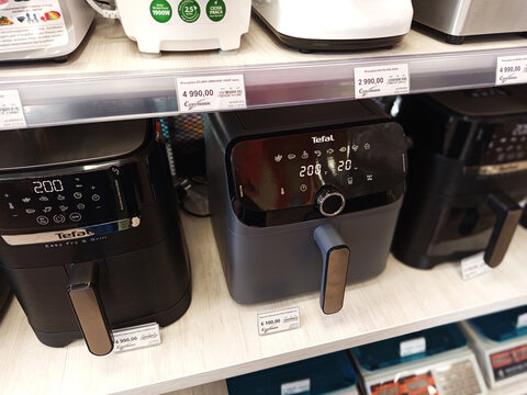 Zvyagel, Ukraine - October 15, 2025: Tefal air fryers displayed on a retail shelf, showcasing modern kitchen appliances with digital controls and sleek designs for healthy cooking options