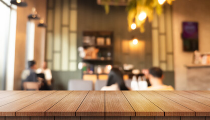 Empty wooden table top with lights bokeh on blur restaurant background.