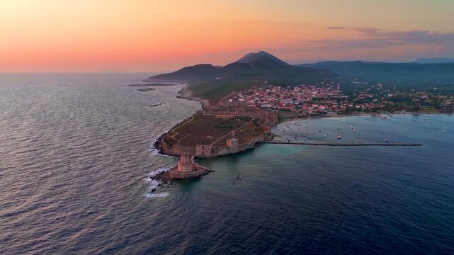 Panoramic aerial view of the old venetian Castle and Bourtzi tower in front of the town of Methoni, Messenia, Peloponnese, Greece, during summer sunset time