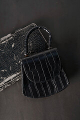 A black bag is placed on a black background.