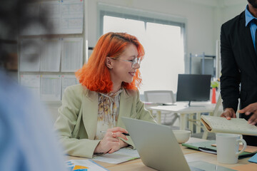 Multicultural business colleagues participate in an energetic office workshop, using artificial intelligence and data-driven insights to brainstorm innovative ideas, align creative strategies