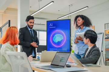 Multicultural business colleagues participate in an energetic office workshop, using artificial intelligence and data-driven insights to brainstorm innovative ideas, align creative strategies