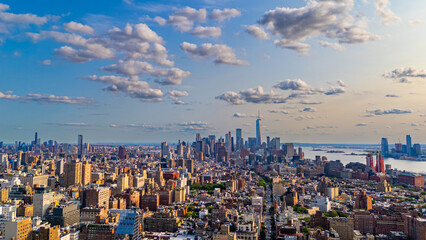 Panoramic aerial view of Manhattan skyline. Wide drone panorama of Manhattan skyline and Hudson River under cloudy summer sky.