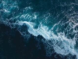 Aerial View of Turbulent Ocean Waves with Foamy White Crests Against Deep Blue Waters