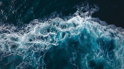 Aerial View of Turbulent Ocean Waves with Foamy White Crests Against Deep Blue Water