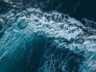 A dynamic ocean wave curls and crashes, showcasing the raw power and beauty of the sea with vibrant blue hues and frothy white foam.