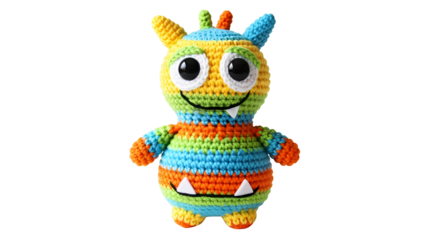 A colorful crocheted monster toy with big eyes and a toothy grin stands up transparent background