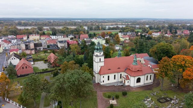 Aerial Solec Kujawski Poland parish church circle 2. Historic village city along Vistula River. Modern city based on historical Polish architecture. Apartment complex, school, sports fields and parks.