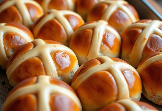 Close-up of several golden-brown hot cross buns, slightly glazed, on a baking sheet, cross, sweet - Powered by Adobe