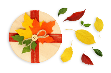 Beautiful gift box decorated with colorful autumn leaves, isolated on a transparent background