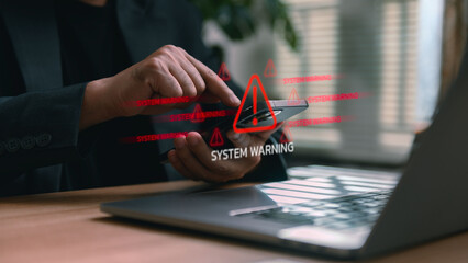 Businessman using smartphone and laptop with digital red system warning alerts, representing cybersecurity risk, malware infection, data breach, and network vulnerability in modern technology.