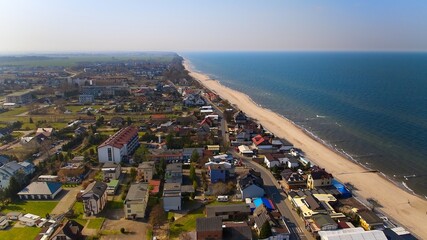 Calm Baltic Sea seen from above, Sarbinowo beach stretching along the coast.