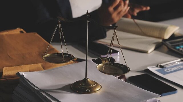 Judge gavel with Justice lawyers having team meeting at law firm background. Concepts of Law and Legal services.